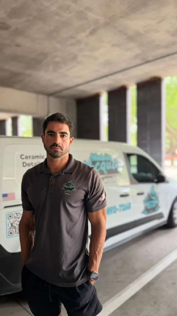Diego, founder of Mobile Acqua Car Wash, in front of the company van
